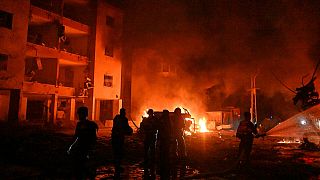 Firefighters work to extinguish a blaze after a missile launched from Iran struck Haifa, in northern Israel, on Sunday, June 15, 2025.