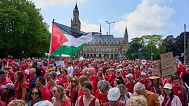 Tens of thousands of red-clad protesters marched past the Peace Palace during a demonstration in The Hague, Netherlands, Sunday, June 15, 2025.