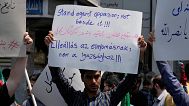 A protester holds up an anti-Israeli placard in a gathering in Tehran, Iran, Friday, June 13, 2025