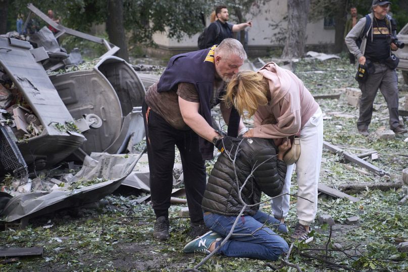 Residents react after a Russian missile hit a multi-storey apartment during Russia's massive missile and drone air attack in Kyiv, Ukraine, Tuesday, June 17, 2025