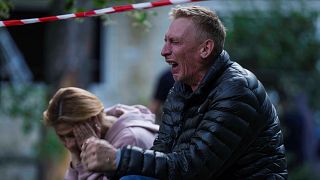 A father cries as his son is under the rubble of a multi-storey residential house destroyed by a Russian strike in Kyiv, Ukraine, on Tuesday, June 17, 2025. 