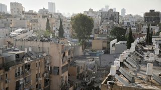 Rescue workers, police and military inspect the site where an Iranian missile struck in Bnei Brak, near Tel Aviv, Israel, Monday, June 16, 2025.