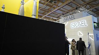Visitors stand by the Israeli pavilions blocked by a black wall at the Paris Air Show Tuesday, June 17, 2025 in Le Bourget, north of Paris.