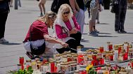People commemorate the victims at the central square in Graz, Austria.