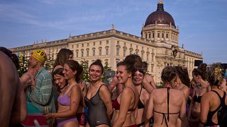 People wait to swim in the river Spree to demand the lift of the hundred years old swimming ban at the river in Berlin, Germany, Tuesday, June 17, 2025.