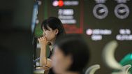 Dealers watch their computer monitors at a dealing room of Hana Bank in Seoul, South Korea. 18 June 2025.