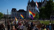 Hungarians march in downtown Budapest to protest against a new law banning LGBTQ+ Pride events and the populist government's restriction on assembly rights. 