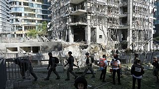 Rescue workers and military personnel inspect the site of a direct hit from an Iranian missile strike in Ramat Gan, Israel, Thursday, June 19, 2025.