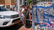 A woman with an M16 rifle stands near to a destroyed building that was hit by a missile fired from Iran, in Holon, near Tel Aviv, Israel, Thursday, June 19, 2025. 