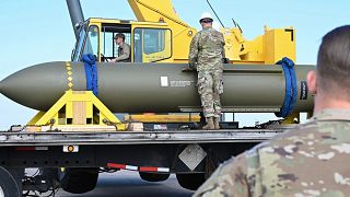 In this photo released by the U.S. Air Force on May 2, 2023, airmen look at a GBU-57, or the Massive Ordnance Penetrator bomb, at Whiteman Air Base in Missouri