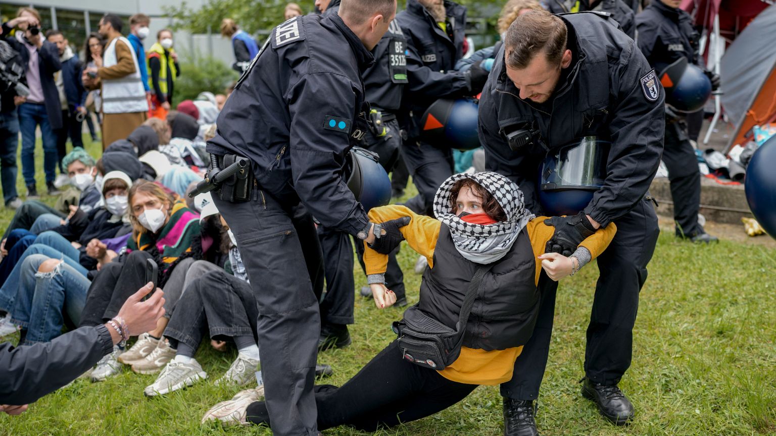 A woman is carried away by police officers during a pro-Palestinians demonstration by the group "Student Coalition Berlin" .