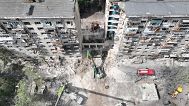 Rescue teams sift through the wreckage on the site of Russia's missile attack that ruined a residential building in Kyiv, 18 June, 2025
