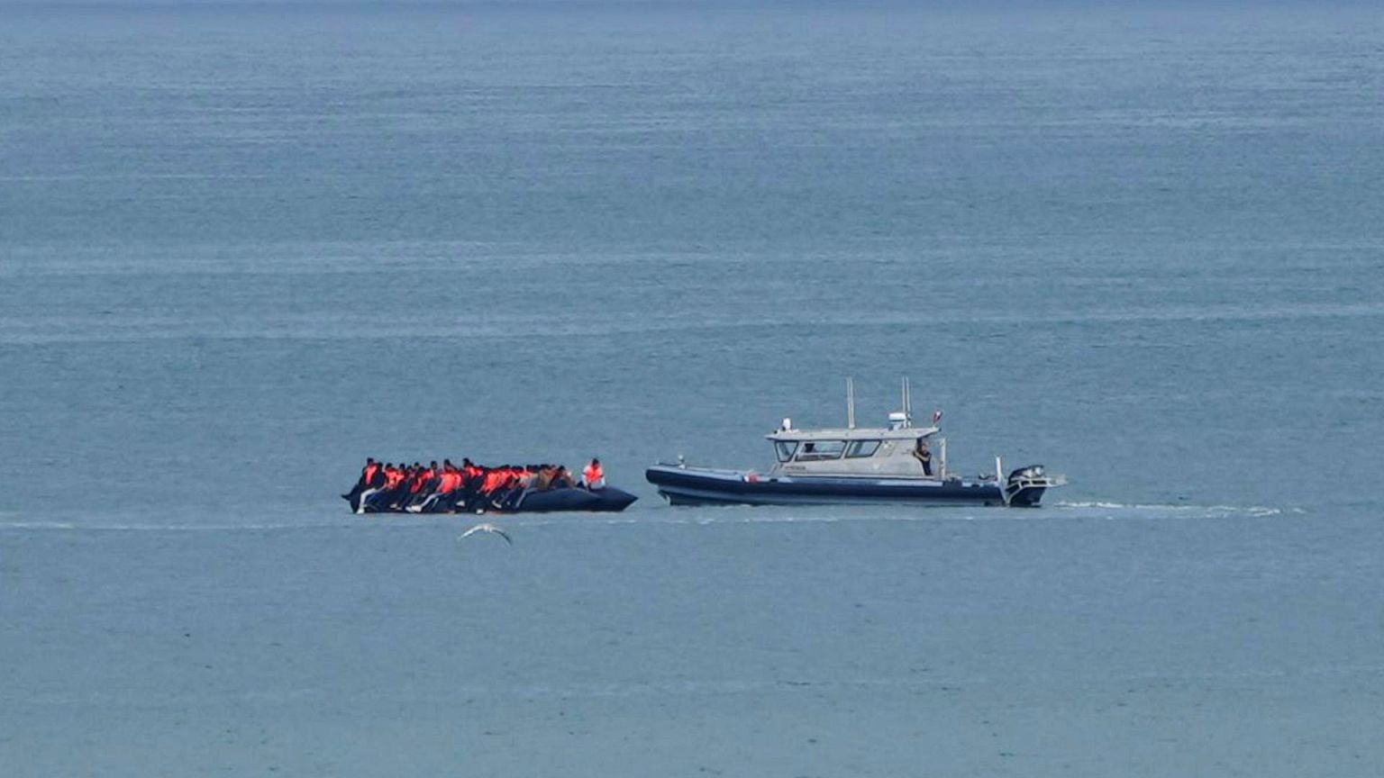 FILE - A boat thought to carry migrants is escorted by a vessel from the French Gendarmerie Nationale in the English Channel, 4 September 2024.