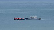 FILE - A boat thought to carry migrants is escorted by a vessel from the French Gendarmerie Nationale in the English Channel, 4 September 2024.