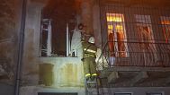 In this photo provided by the Ukrainian Emergency Service, firefighters evacuate a resident from the burning apartment building following Russia's massive air attack in Odesa.