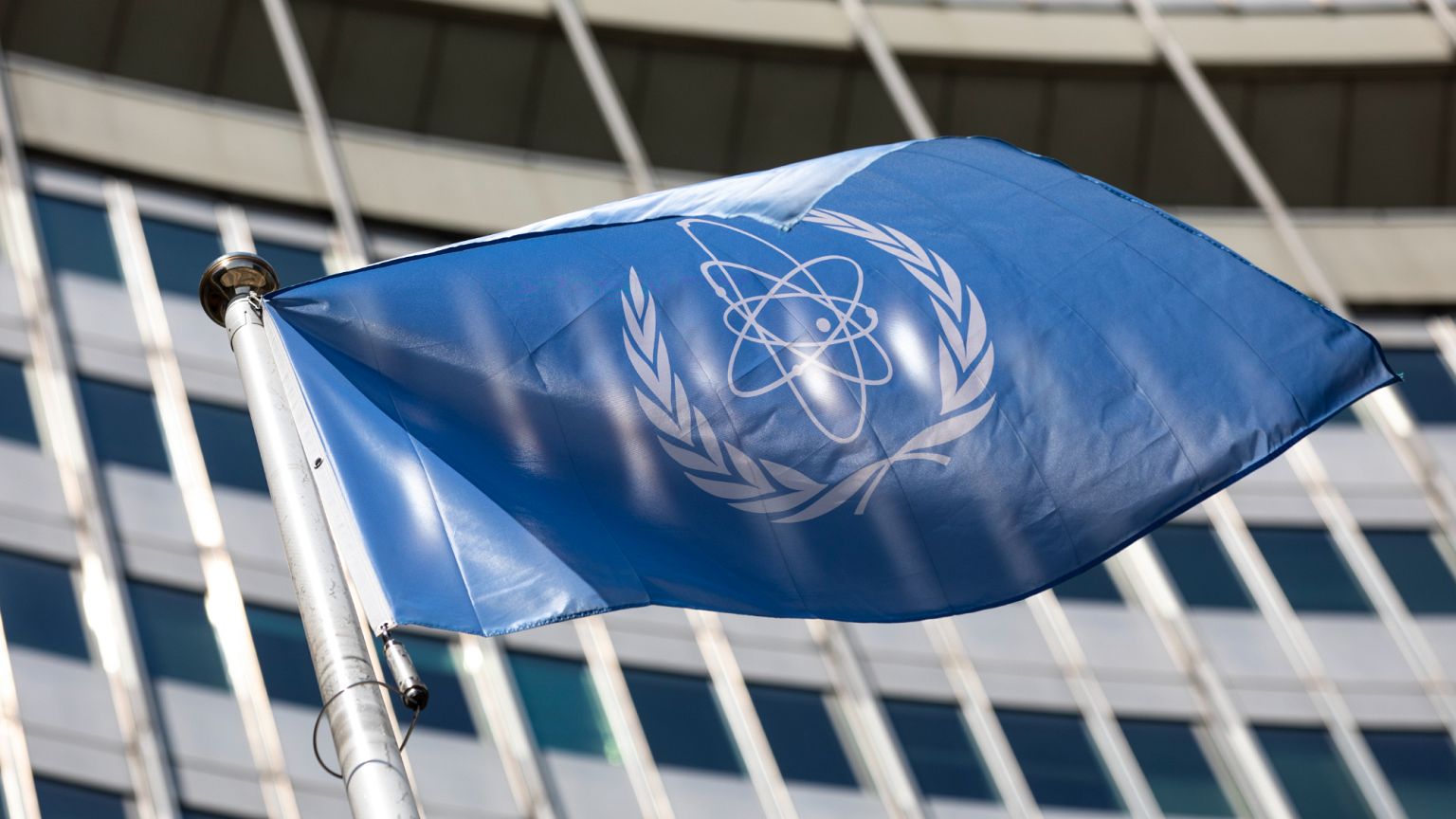 FILE - In this June 7, 2021, file photo, the flag of the International Atomic Energy Agency (IAEA) waves at the entrance of the Vienna International Center in Vienna. (AP Phot