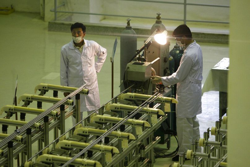 Iranian technicians work at a new facility producing uranium fuel for a planned heavy-water nuclear reactor outside the city of Isfahan, 9 April, 2009
