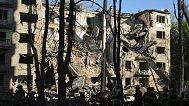 Firefighters work in a destroyed apartment building after a Russian attack in Kyiv, Ukraine, early Monday, June 23, 2025.