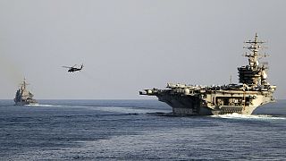 The aircraft carrier USS Dwight D. Eisenhower and other warships crosses the Strait of Hormuz into the Persian Gulf on Sunday, Nov. 26, 2023.