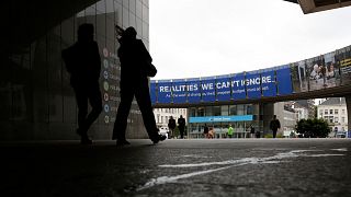 A woman walks past the European Parliament in Brussels on Tuesday 27 May 2025. 