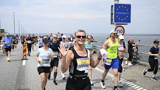 Runners cross the border between Sweden and Denmark over the Øresund bridge.