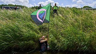 Police repel demonstrators who crossed a moat in an attempt to block the A44 motorway  in Abbenes, Netherlands, Monday, June 23, 2025