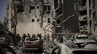 Israeli soldiers from the Home Front Command unit work at the site struck by an Iranian missile strike that killed several people, in Beersheba, Israel, on Tuesday, June 24.