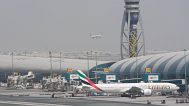 An Emirates Boeing 777 stands at the gate at Dubai International Airport.