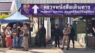A Thai police officer talks to people near a border checkpoint between Thailand and Cambodia, in Sa Kaeo Province in Thailand, 24 June, 2025