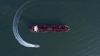 In this Sunday, July 21, 2019 photo, an aerial view shows a speedboat of Iran's Revolutionary Guard moving around the British-flagged oil tanker Stena Impero.