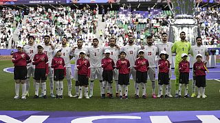 Iranian players stand for the national anthem before the AFC Asian Cup quarter-final match between Japan and Iran at the Education City Stadium in Al Rayyan, Qatar