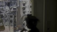 A police officer inspects a damaged apartment a day after a direct missile strike from Iran hit a residential building, following the announcement of a ceasefire, in Beersheba