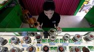 A staff prepares flower bud of cannabis for a customer at cannabis shop in Bangkok, Thailand, July 18, 2024.