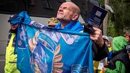 A freed Ukrainian soldier holds up his unit's flag after a POWs exchange with Russia