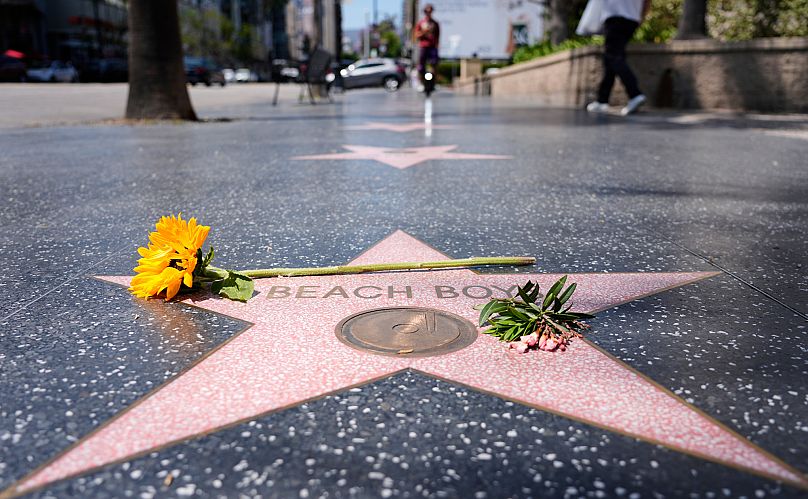A sunflower lies on the Beach Boys' star on the Hollywood Walk of Fame after the announcement of his death - 11 June 2025