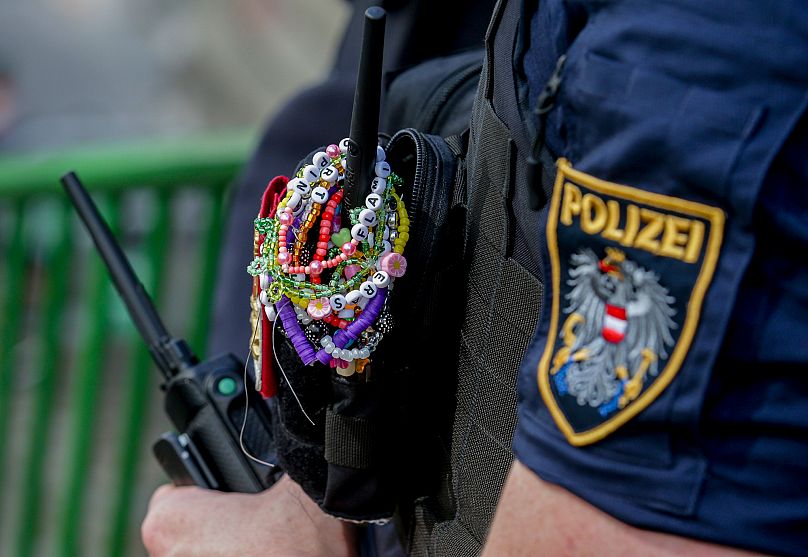 A police officer is decorated with Taylor Swift bracelets while guarding the city center in Vienna - 8 August 2024