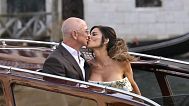 Jeff Bezos, center left, and Lauren Sanchez, center right, kiss as they leave a hotel for their pre wedding reception, in Venice, Italy, Thursday, June 26, 2025.