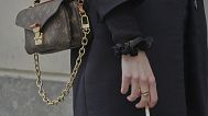 A woman holds a cigarette during a break in Paris on Wednesday 28 May 2025.