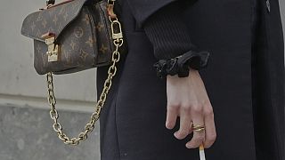 A woman holds a cigarette during a break in Paris on Wednesday 28 May 2025.