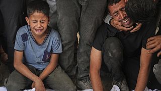 Relatives react as they mourn over the body of a loved one killed, along with others, in Israeli strikes on the Gaza Strip, at Al-Shifa Hospital in Gaza City, June 28.2025
