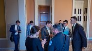 Congressional staff wait outside a Republican meeting