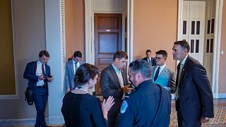 Congressional staff wait outside a Republican meeting