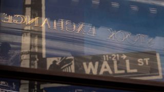 A reflection of a window shows the New York Stock Exchange. 30 June 2025. 