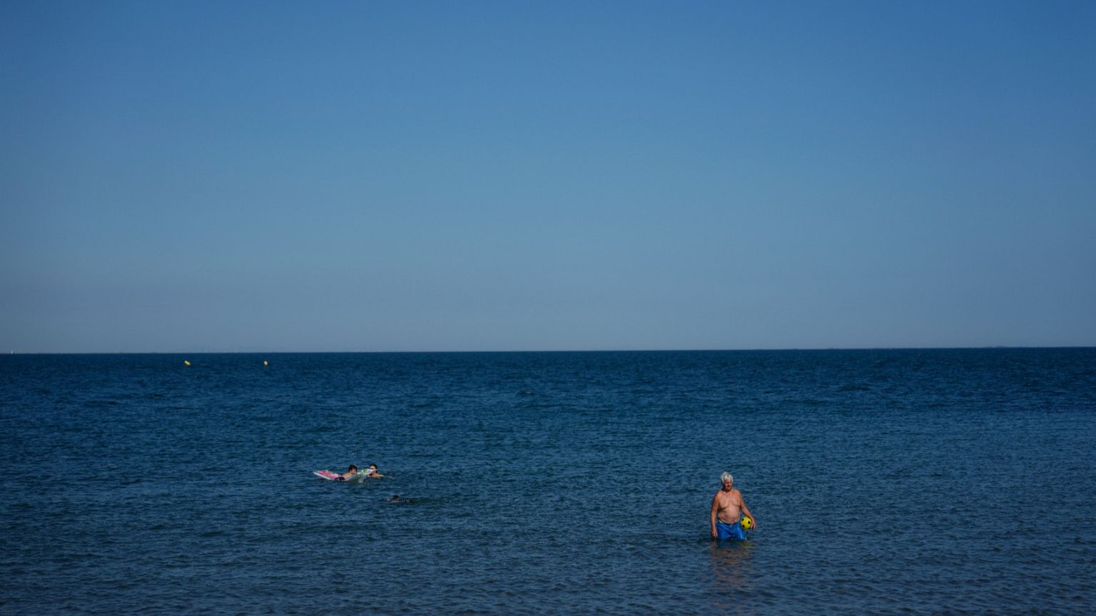 Beachgoers enjoy the sea during a heat wave Monday 30 June in Saintes-Maries-de-la-Mer, southern France.