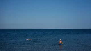 Beachgoers enjoy the sea during a heat wave Monday 30 June in Saintes-Maries-de-la-Mer, southern France.