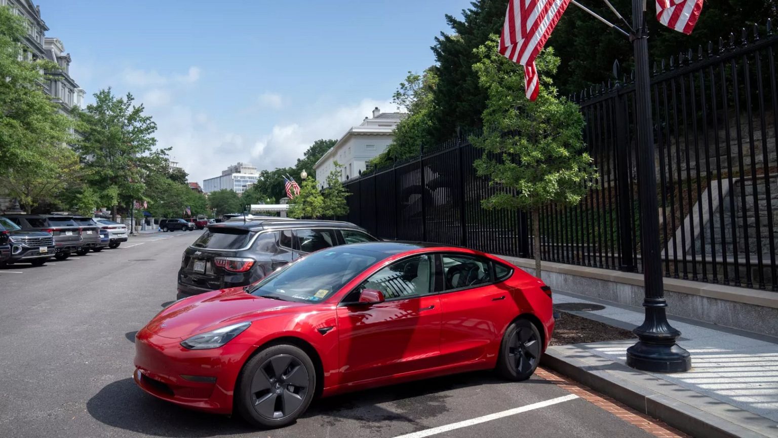 A red Tesla is parked on West Executive Drive on the White House campus, Monday, June 9, 2025, in Washington. 