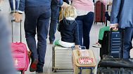 A boy is pulled on a suitcase when German ver.di union went on a warning strike at German airports in Frankfurt, Germany, Wednesday, April 27, 2016