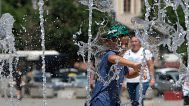 A boy plays in a fountain during hot weather in Kosovo's capital Pristina, 3 July, 2025 