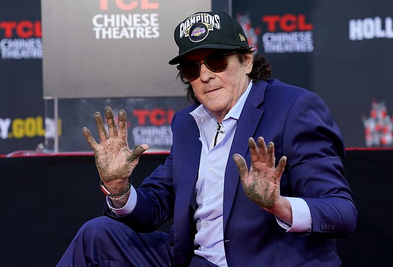 Actor Michael Madsen holds up his hands after putting them in cement during a ceremony for him at the TCL Chinese Theatre in Los Angeles, 16 November, 2020