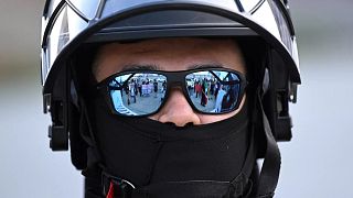 A U.S. Customs and Border Patrol agent looks on during a protest outside the Federal Building on Friday, June 13, 2025, in Los Angeles.